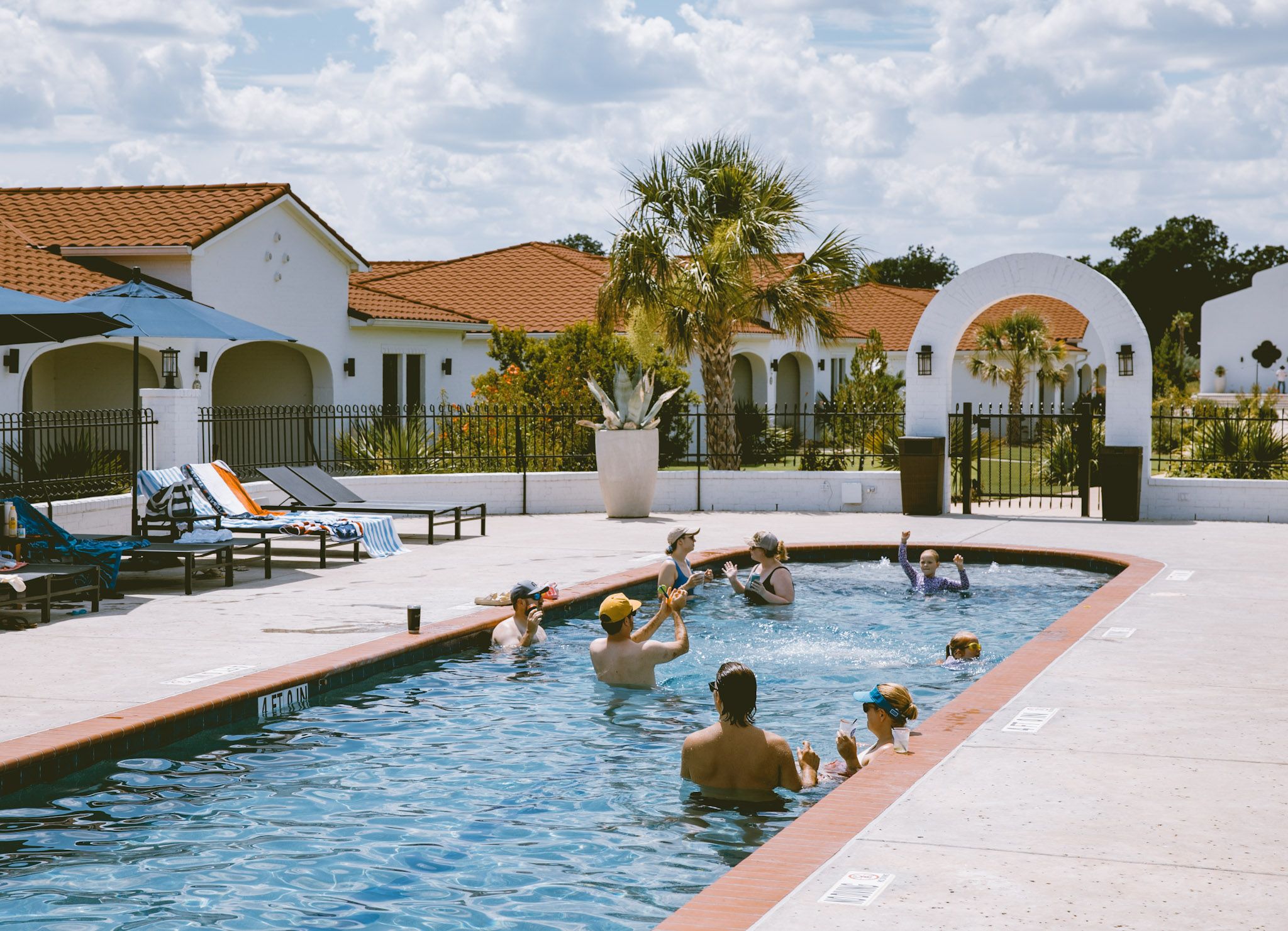 Palm over a quiet pool with white arches